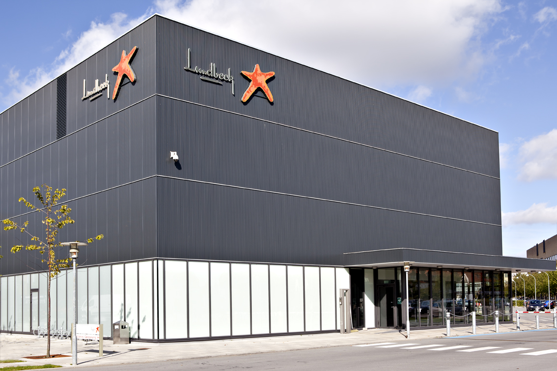 up to data | Lundbeck office building with company logo and signage against blue sky